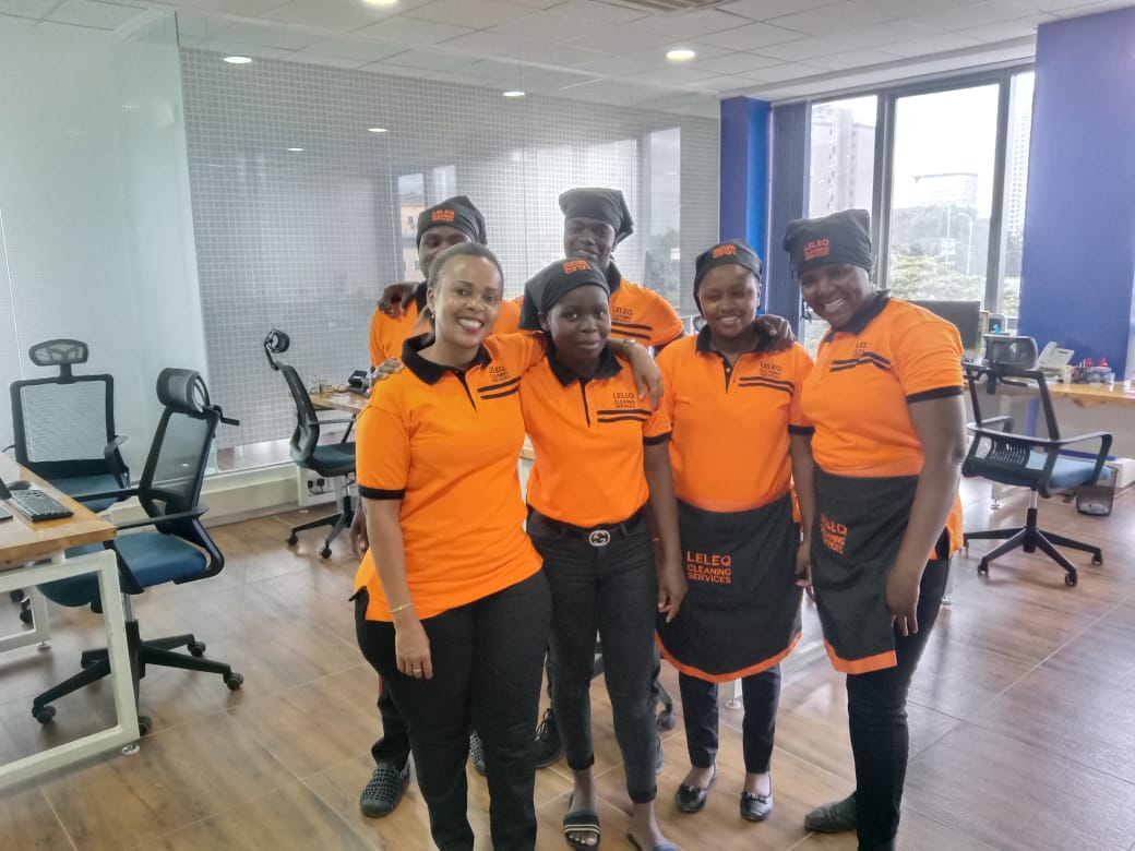 Professional LELEQ cleaning team in orange uniforms
